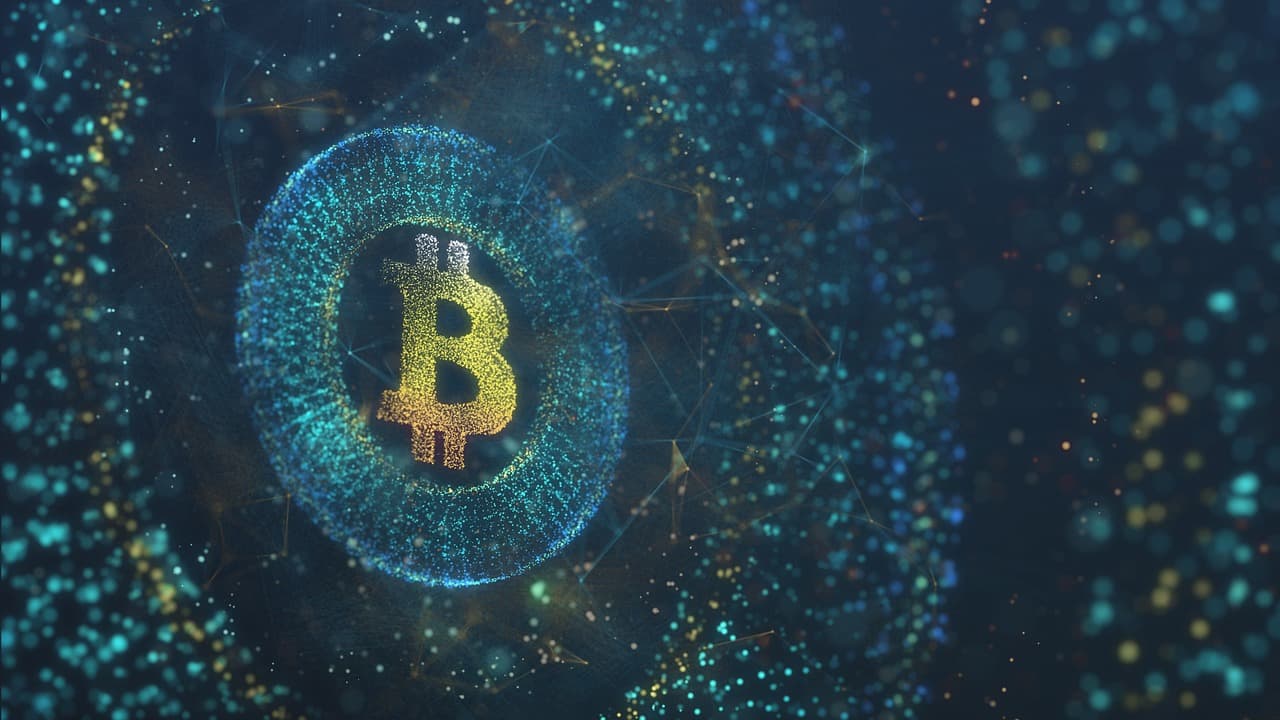 The Bitcoin logo in gold being shown by tons of little dots and a network of these dots all floating around it in a circle.