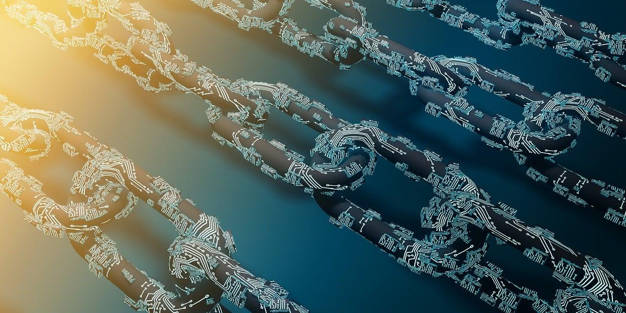 A darkly colored metal chain with light blue technology wires attached to it with the yellow sun shining down on top of it.