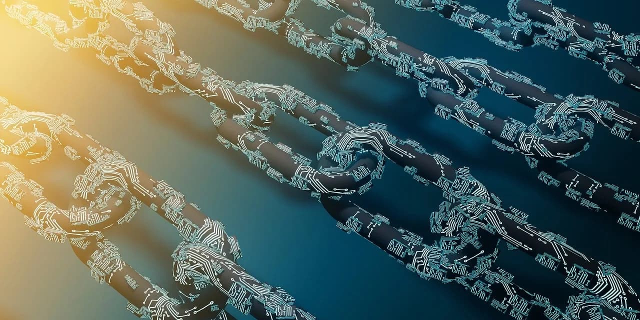 A darkly colored metal chain with light blue technology wires attached to it with the yellow sun shining down on top of it.