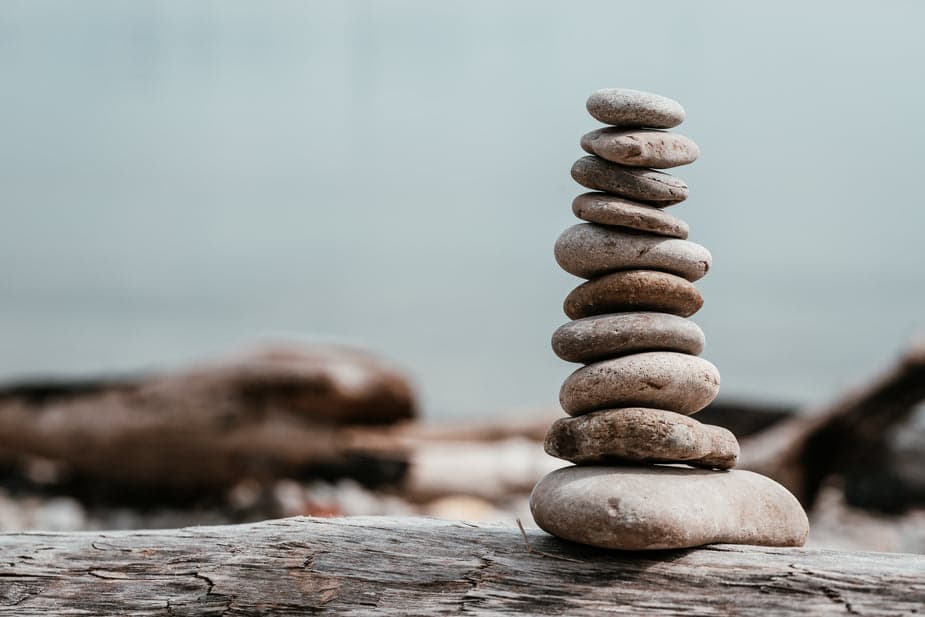 Ten stones all stacked on top of each other with the largest on the bottom and slowly going smaller in size until the top.