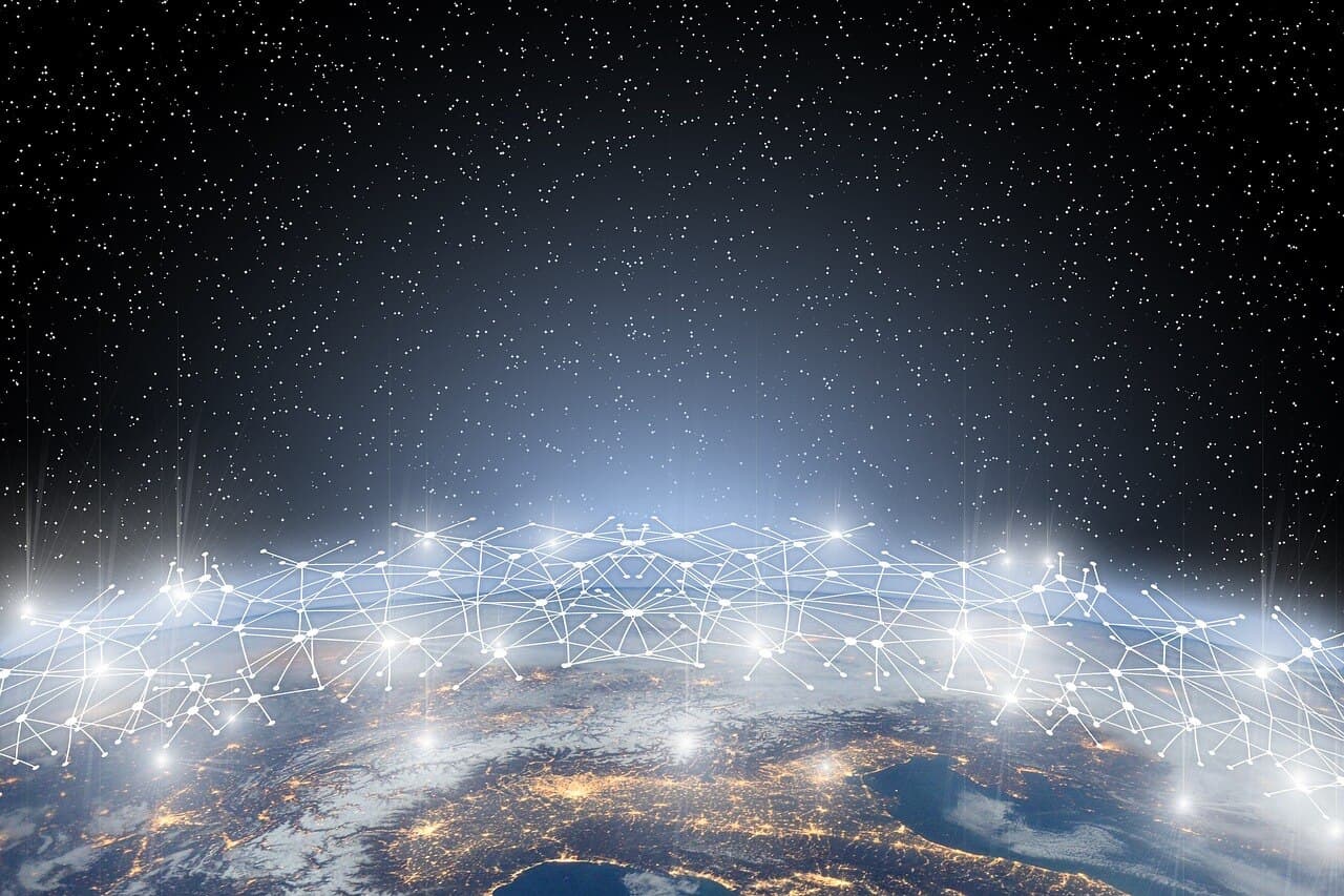 The earth in space with a bunch of lines and dots connecting to each other to build a network with stars all above the planet.