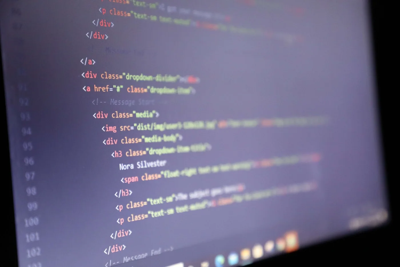 HTML code on a mac laptop that is in the process of being made into a website with different types of tags.