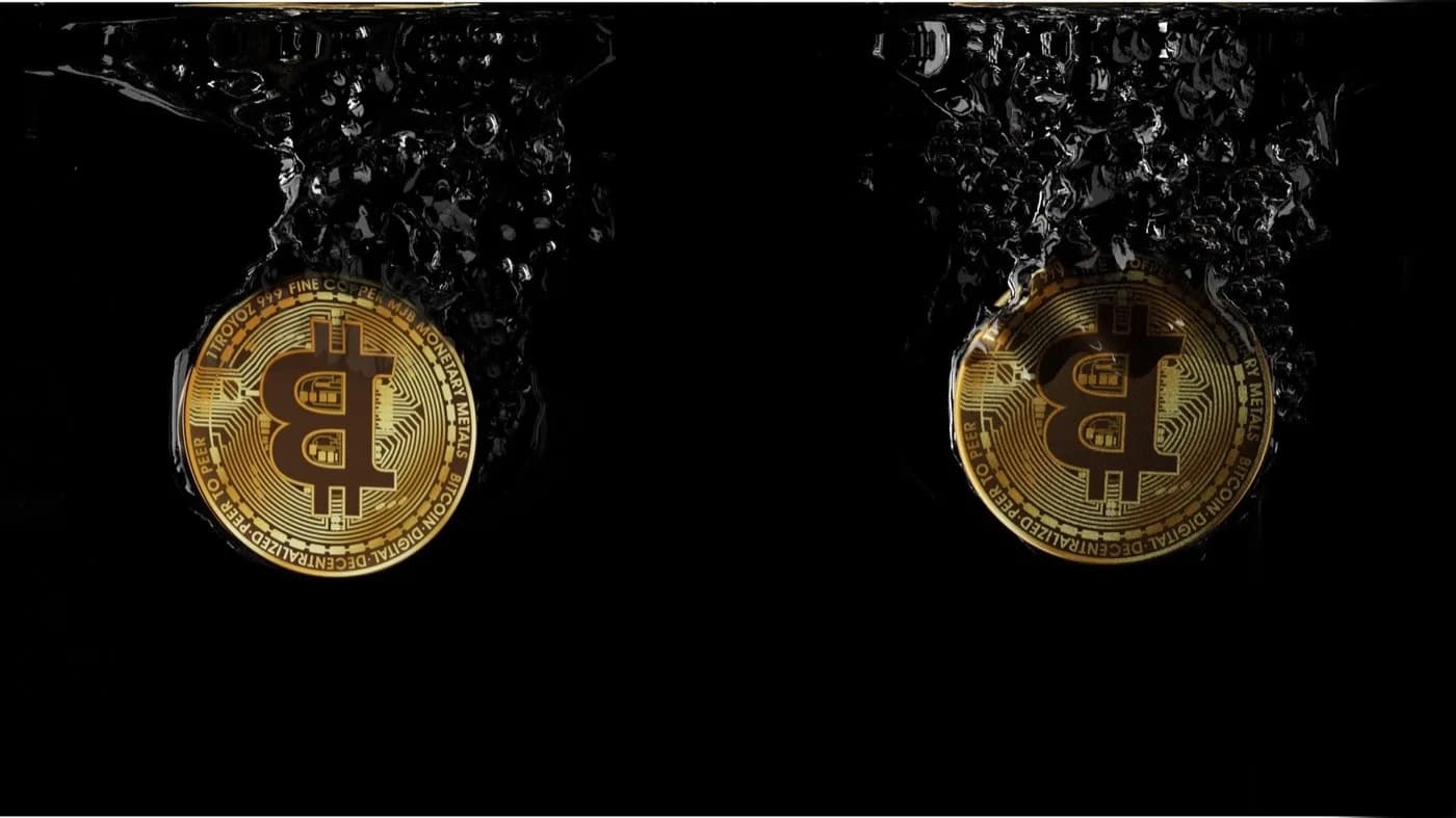 Two bitcoin falling from above that are slowly deteriorating, leaving behind a white smoke in front of a black background.