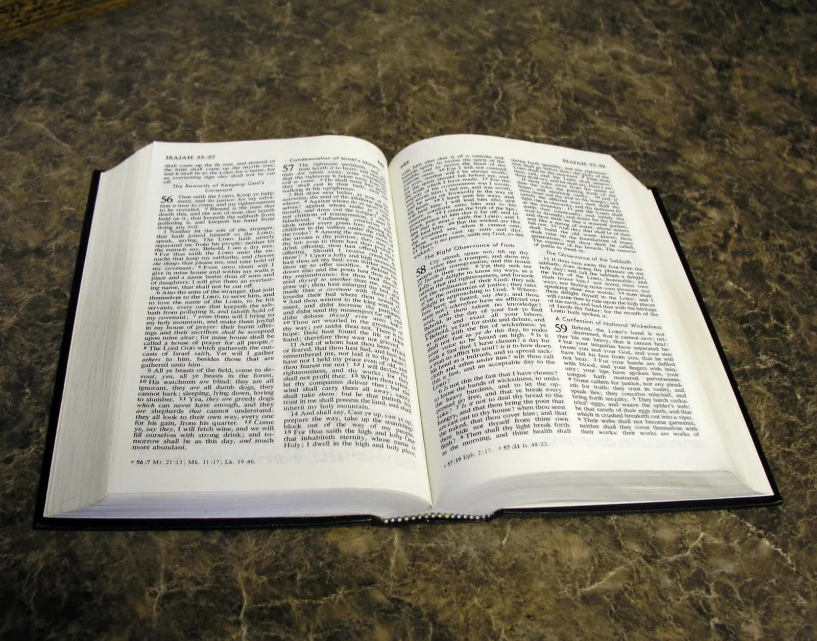 Open Bible showing two pages of Scripture, the text an AI Bible chatbot like Kairos points seekers toward